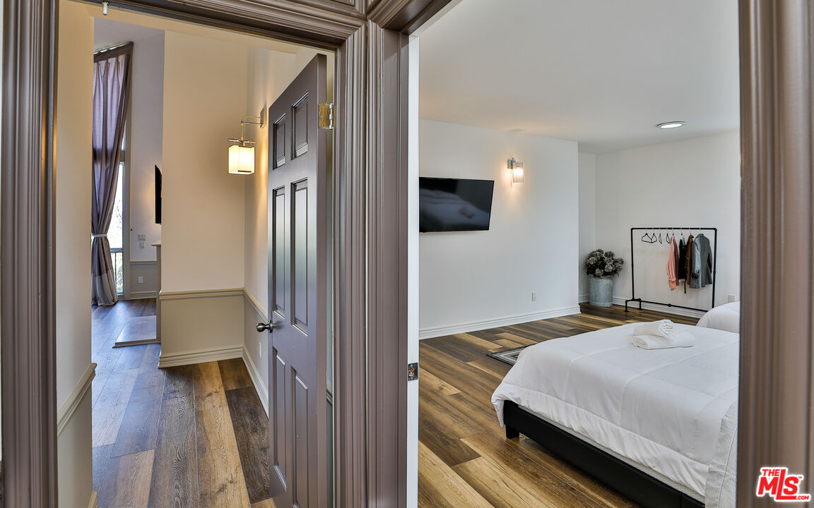 14839 Valley Vista Boulevard Sherman Oaks, CA 91403 - Photo 39 of 65 a bedroom with a bed and a flat tv screen on dresser