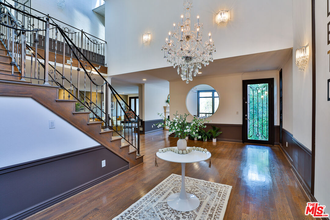 14839 Valley Vista Boulevard Sherman Oaks, CA 91403 - Photo 4 of 65 a view of a dining room with furniture a chandelier and wooden floor