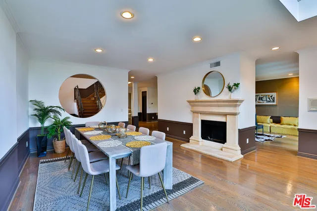 a view of a patio with a table and chairs and wooden fence