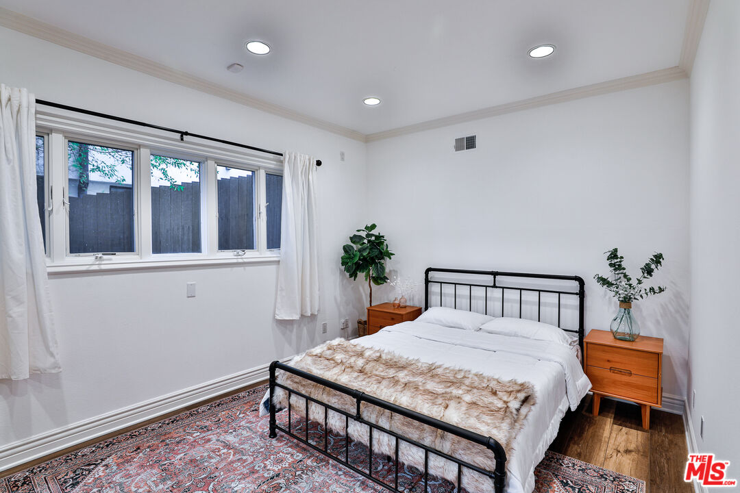 14839 Valley Vista Boulevard Sherman Oaks, CA 91403 - Photo 47 of 65 a bedroom with furniture and a window