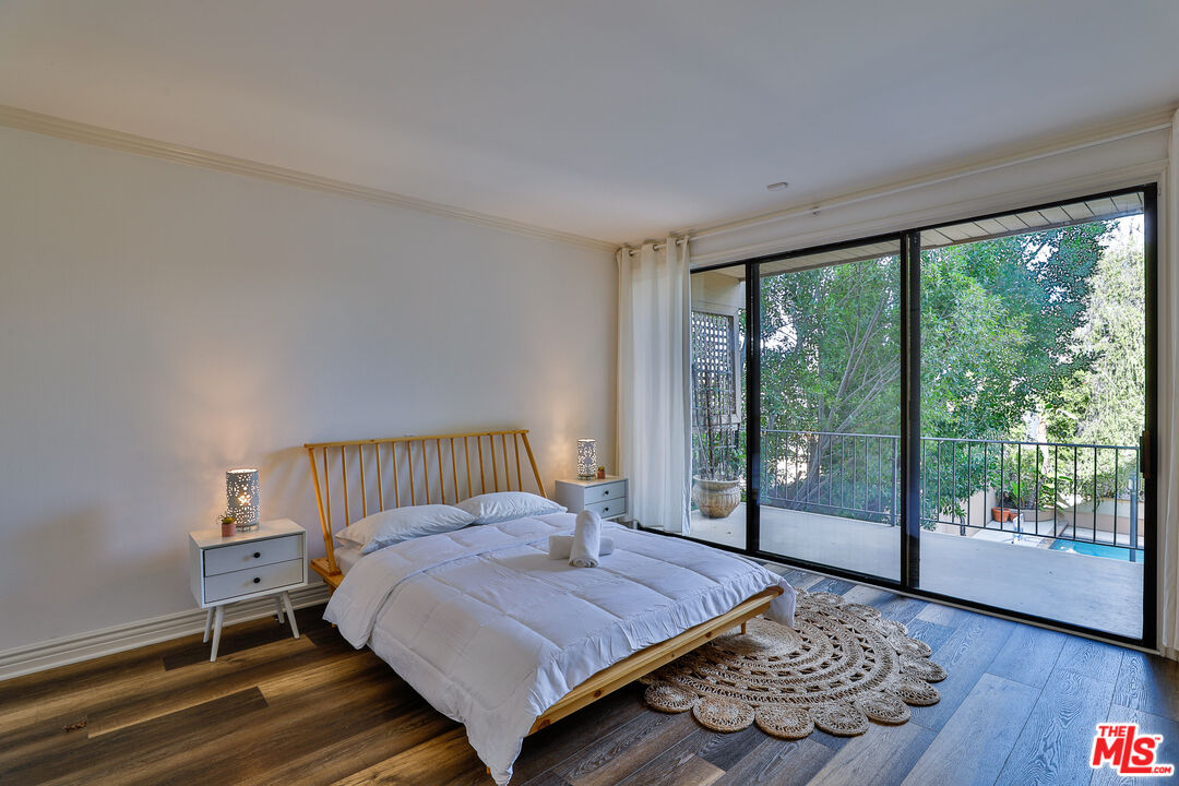 14839 Valley Vista Boulevard Sherman Oaks, CA 91403 - Photo 54 of 65 a bedroom with a bed and wooden floor