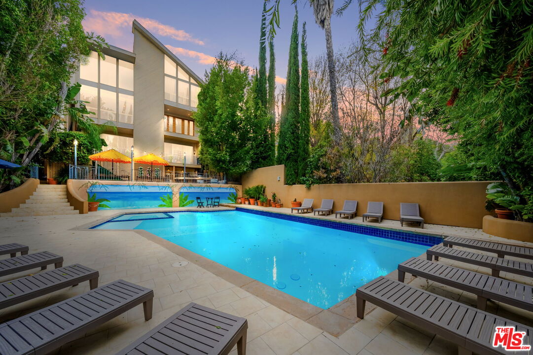 14839 Valley Vista Boulevard Sherman Oaks, CA 91403 - Photo 63 of 65 a view of a swimming pool with a lounge chairs