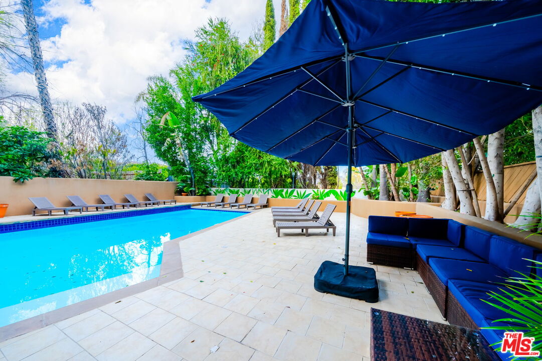 14839 Valley Vista Boulevard Sherman Oaks, CA 91403 - Photo 7 of 65 a view of patio with table and chairs under an umbrella