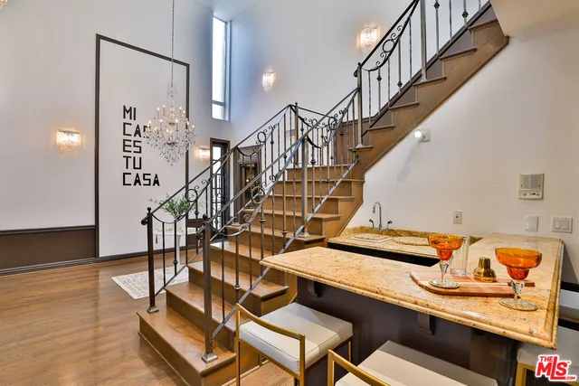 an outdoor sitting area with couch and wooden fence