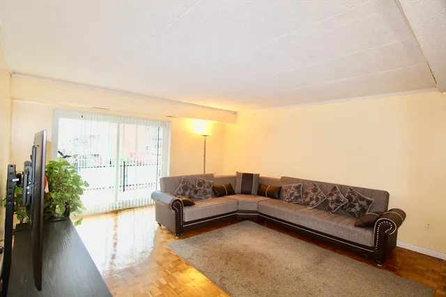 a living room with furniture and a large window