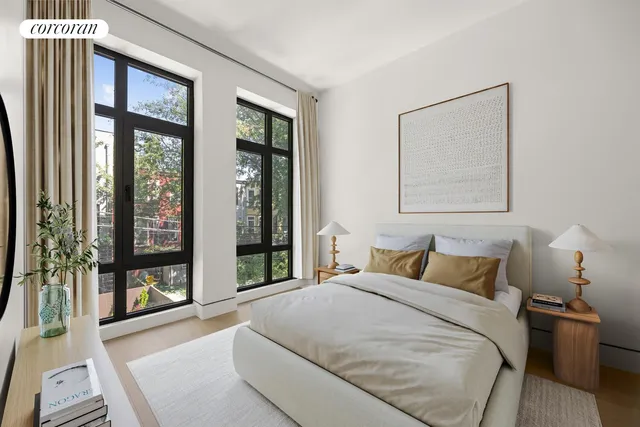 a bedroom with a bed a mirror and a large window