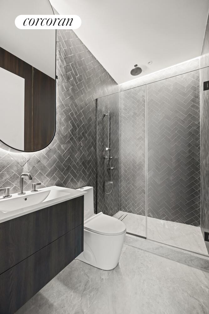 259 Halsey Street, Unit 3R Brooklyn, NY 11216 - Photo 6 of 10 a bathroom with a sink and a mirror