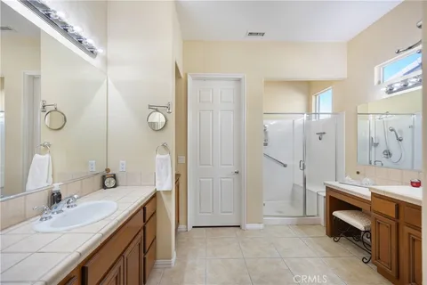 a spacious bathroom with a double vanity sink mirror and double