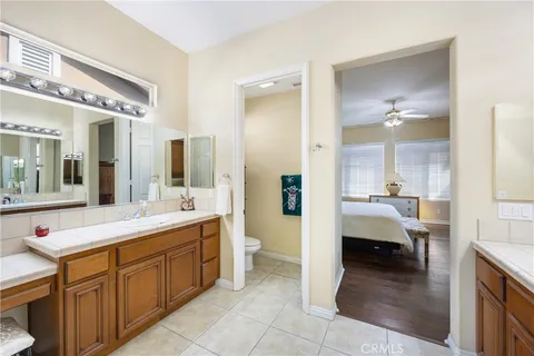 a large bathroom with a double vanity sink a large mirror and a bathtub