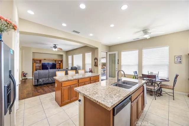 a view of a kitchen with kitchen island granite countertop lots of counter top space