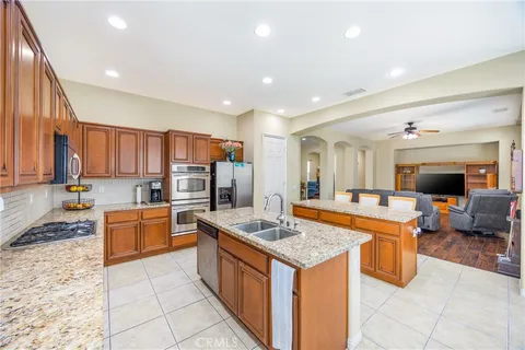 a kitchen with a sink counter top space appliances and cabinets