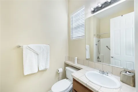 a bathroom with a sink toilet and mirror