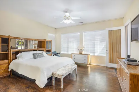 a bedroom with a large bed and a chandelier