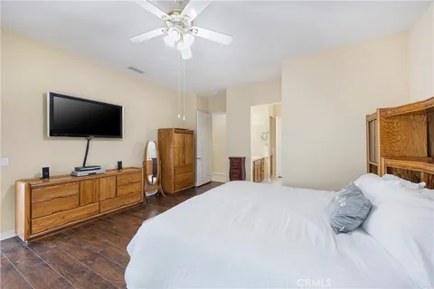 a bedroom with a bed and flat screen tv