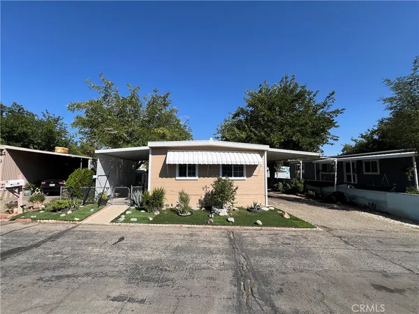 a front view of house with yard outdoor seating and green space