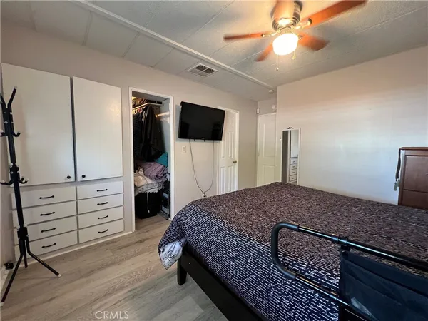a bedroom with a walk in closet and a window