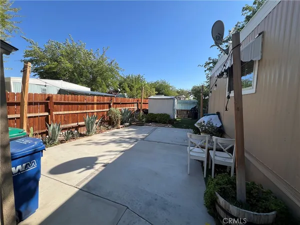 a view of backyard with outdoor seating and plants
