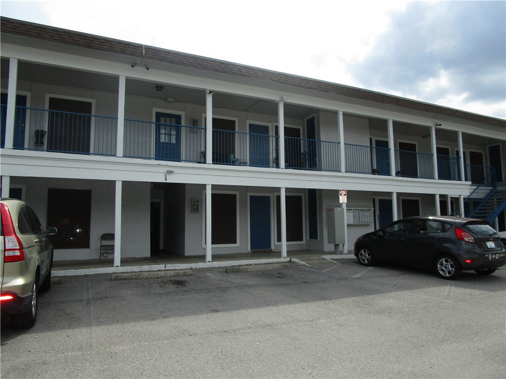 4709 Harmon Avenue, Unit 321 Austin, TX 78751 - Photo 1 of 1 a couple of cars parked in front of a building