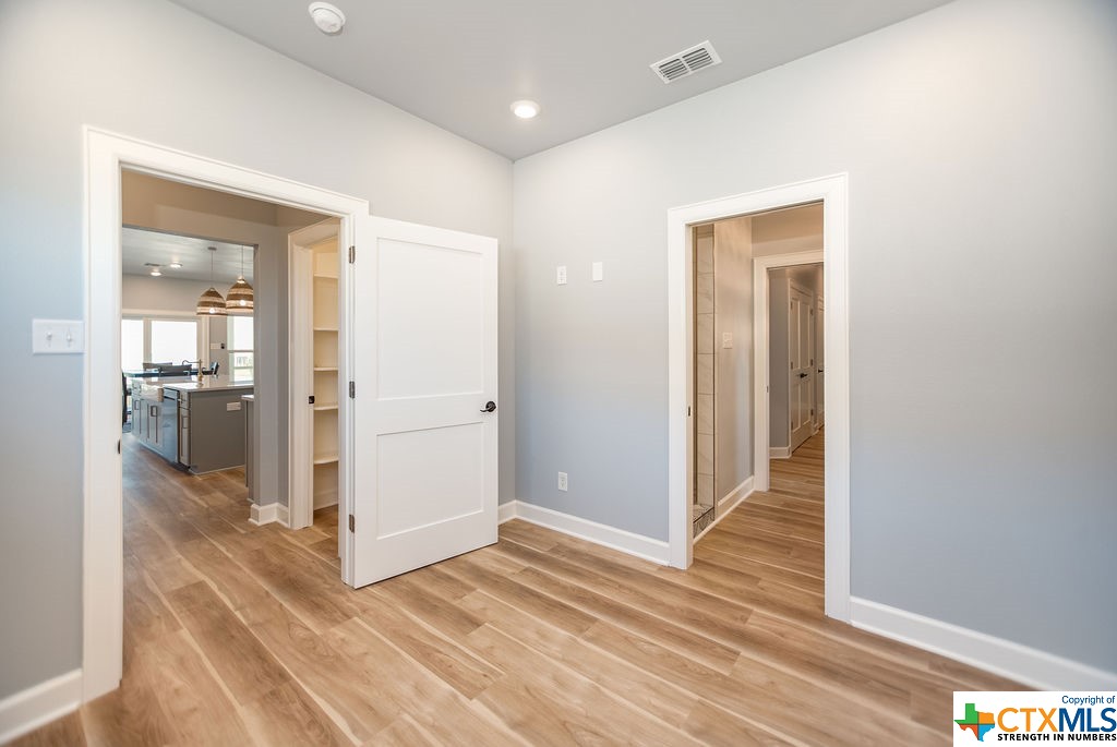 109 Whooping Crane Street Port O'Connor, TX 77982 - Photo 16 of 48 a view of a hallway with wooden floor and a bathroom