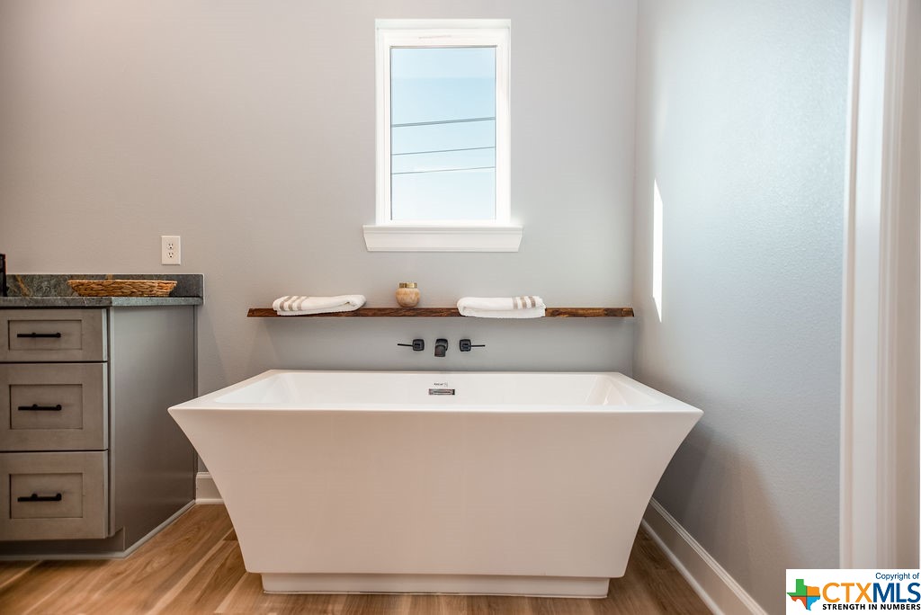 109 Whooping Crane Street Port O'Connor, TX 77982 - Photo 25 of 48 a white bath tub sitting in a bathroom