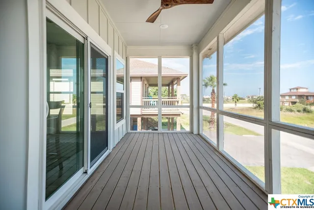 a view of a room with wooden floor and windows