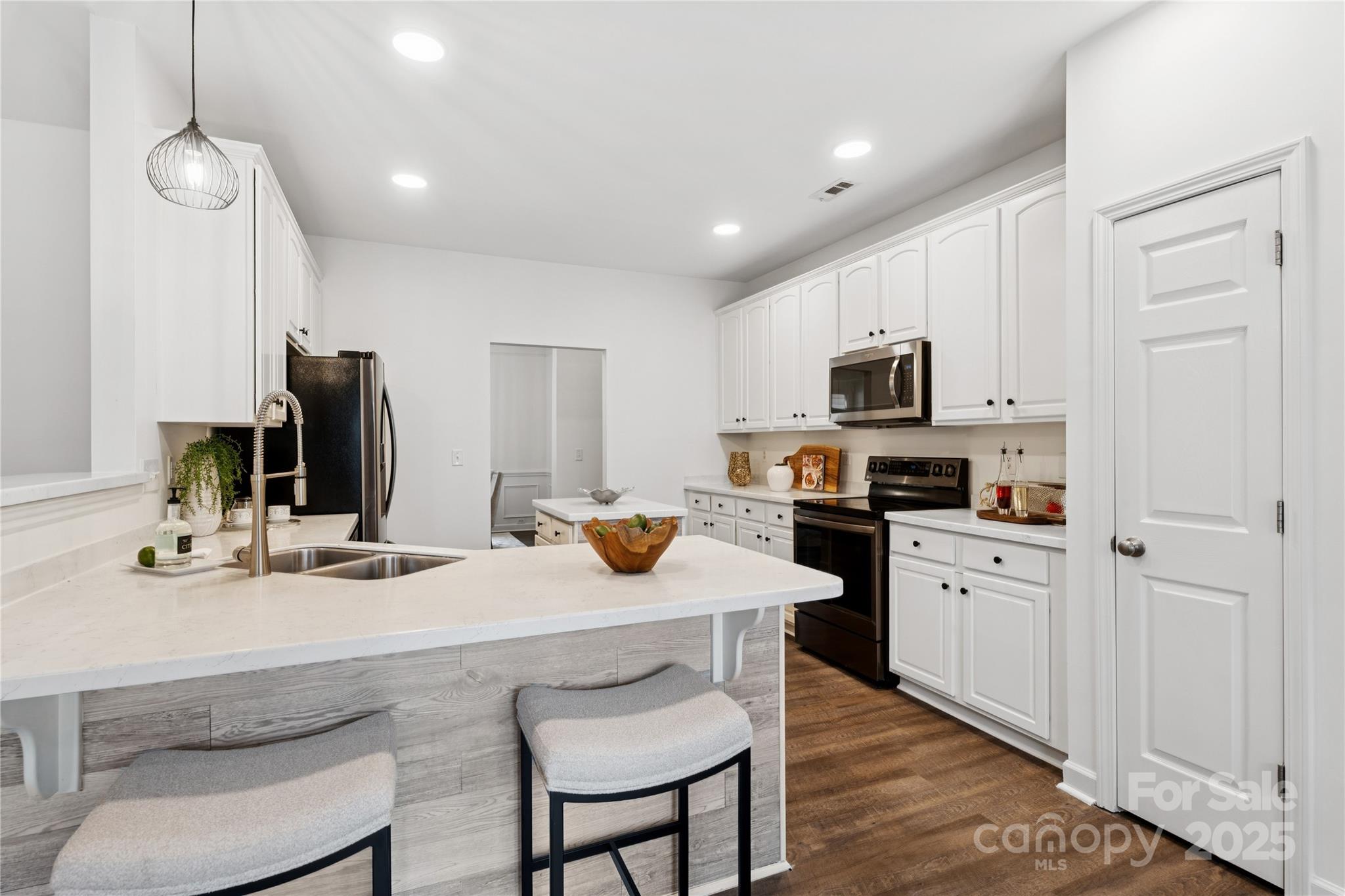 312 Albany Street Fort Mill, SC 29715 - Photo 9 of 36 a kitchen with white cabinets and stainless steel appliances