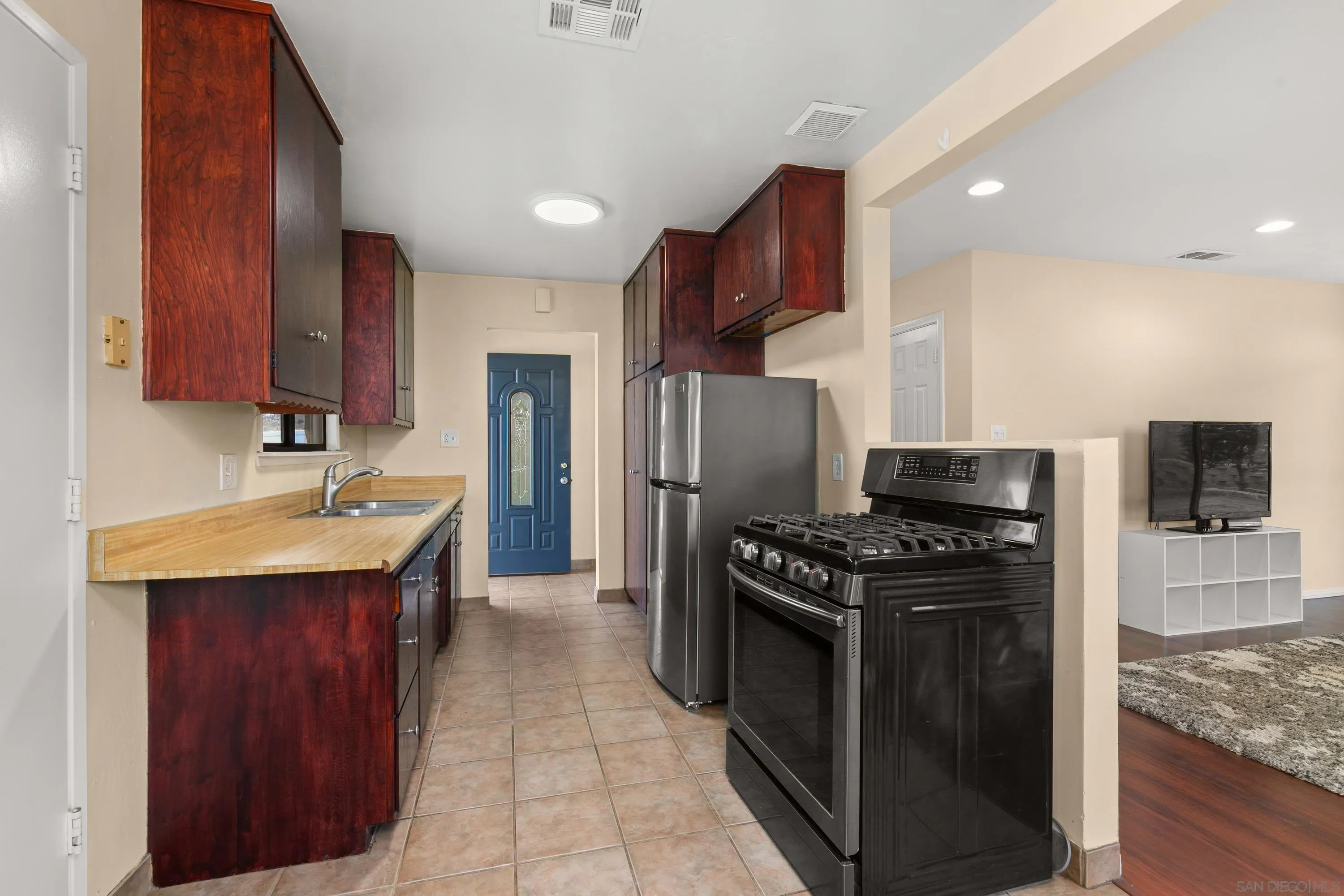 13314 Powers Road Poway, CA 92064 - Photo 15 of 44 a kitchen with stainless steel appliances granite countertop a stove a refrigerator and a sink