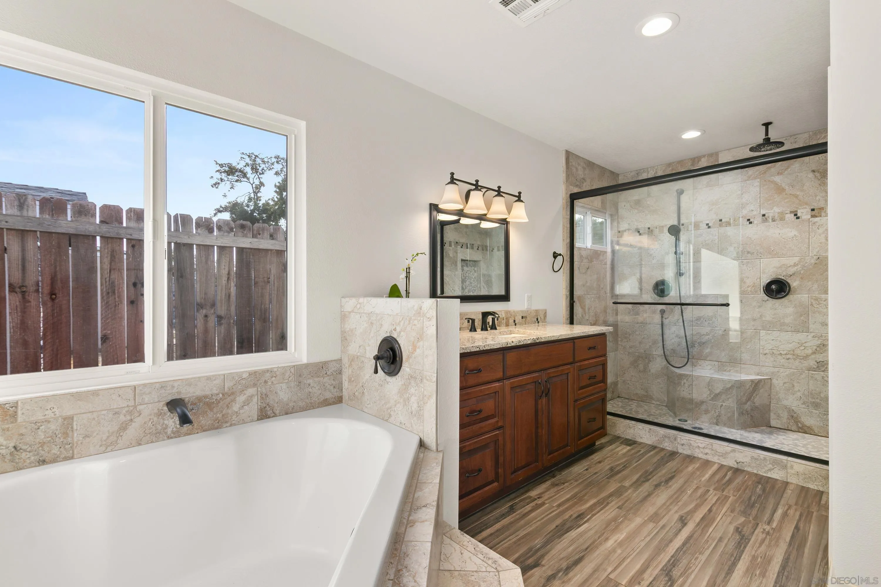 13314 Powers Road Poway, CA 92064 - Photo 19 of 44 a bathroom with a tub sink shower and mirror
