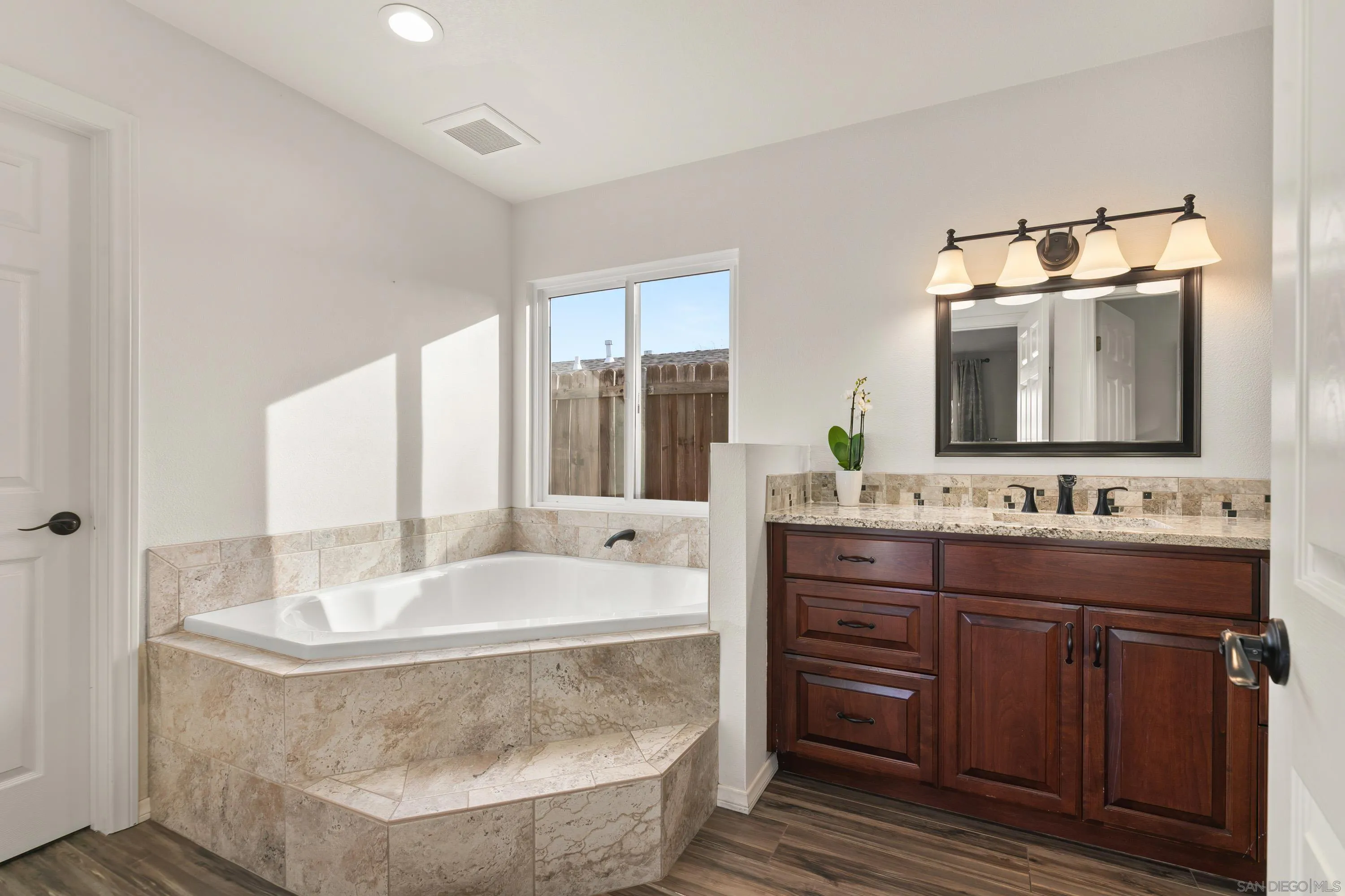 13314 Powers Road Poway, CA 92064 - Photo 20 of 44 a bathroom with a tub sink and mirror