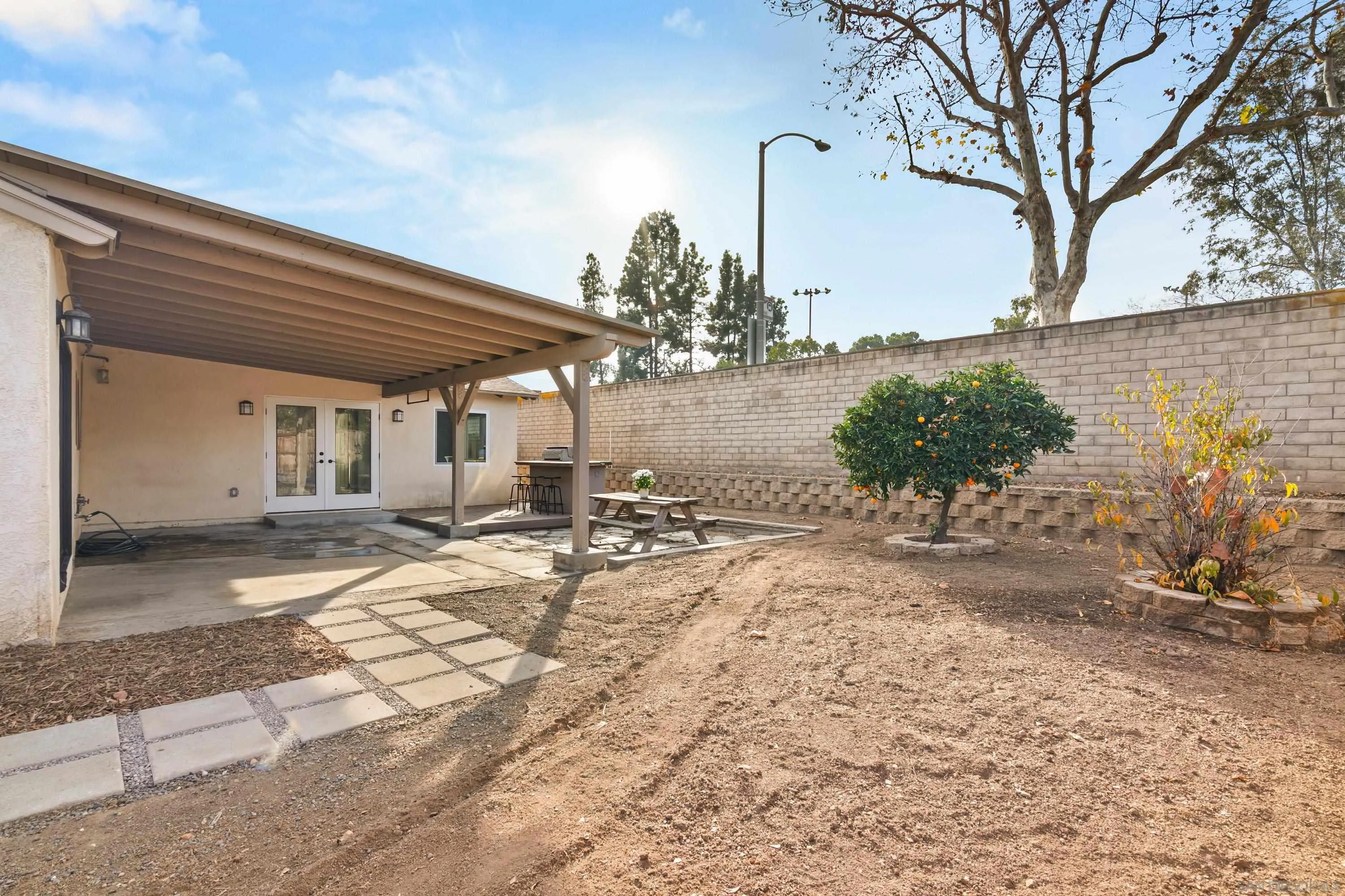 13314 Powers Road Poway, CA 92064 - Photo 34 of 44 a view of a backyard with table and chairs under an umbrella