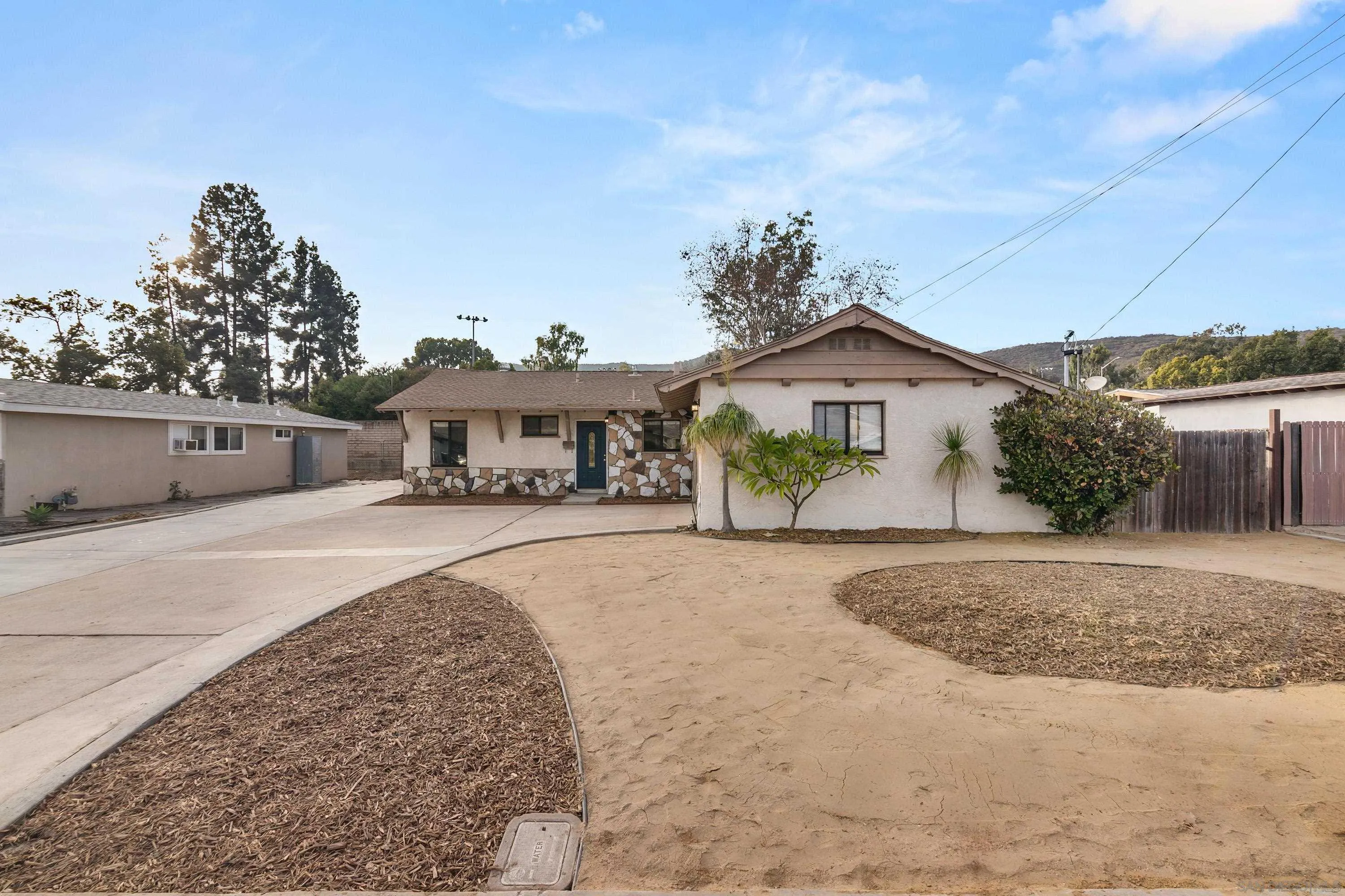 13314 Powers Road Poway, CA 92064 - Photo 39 of 44 a front view of a house with a yard and potted plants