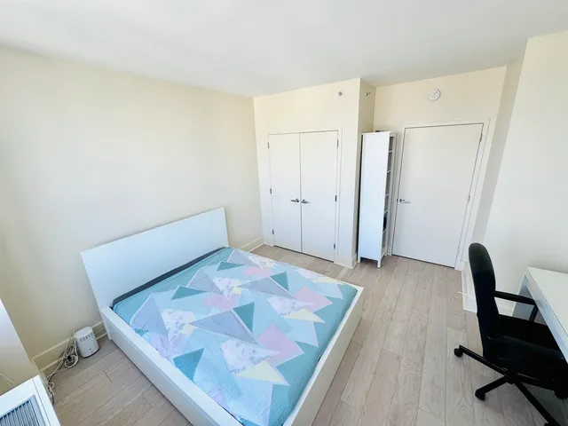 a bedroom with a bed and chair