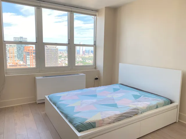 a bedroom with a bed and window