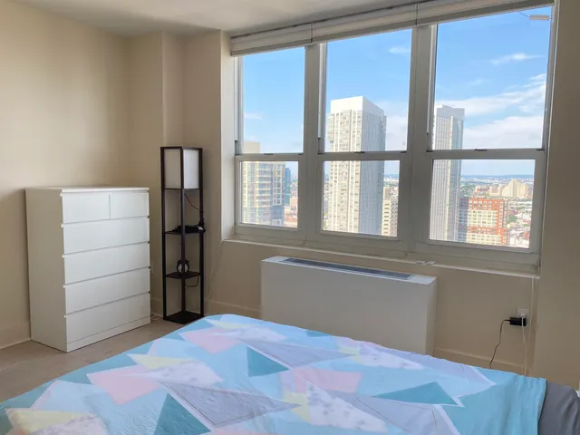 a view of empty room with cabinet and floor to ceiling window