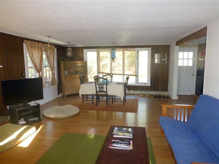 335 Cove View Road Wellfleet, MA 02667 - Photo 9 of 25 a living room with fireplace furniture and a flat screen tv