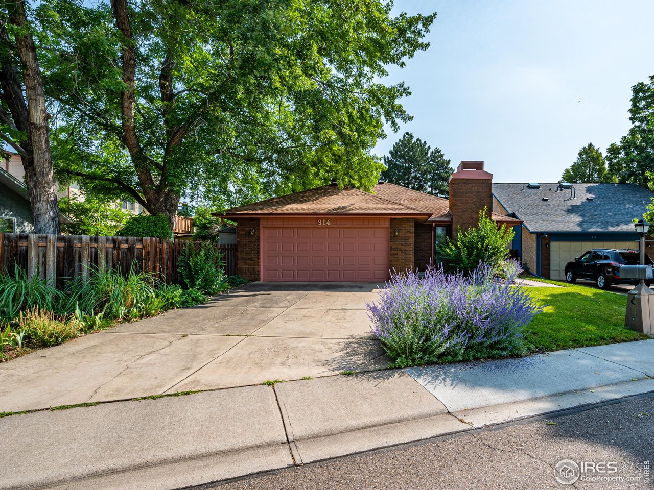 a front view of house with a garden
