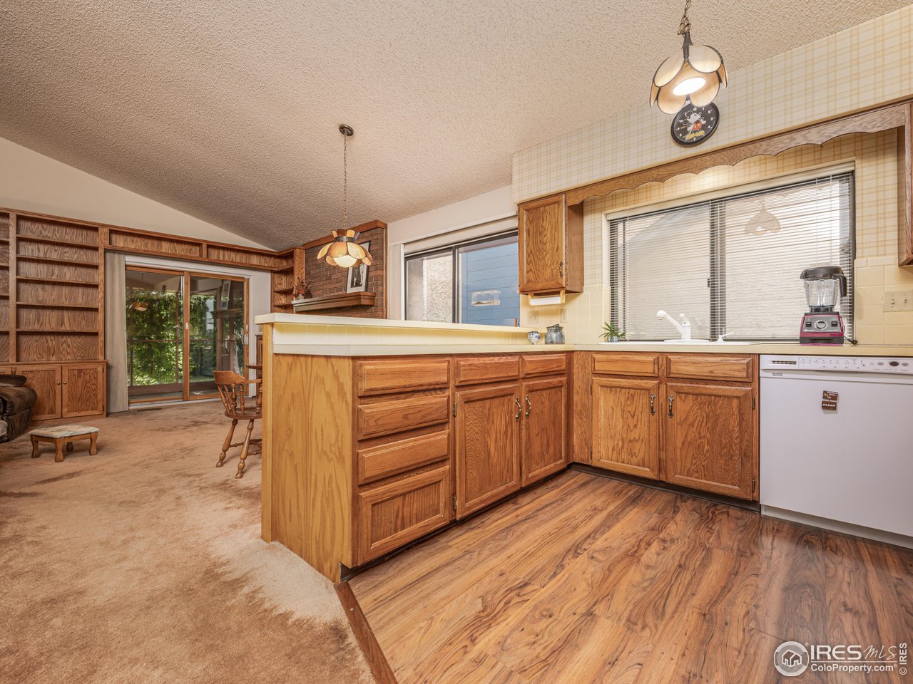 314 Eagle Court Longmont, CO 80504 - Photo 16 of 40 a kitchen with a sink window and cabinets