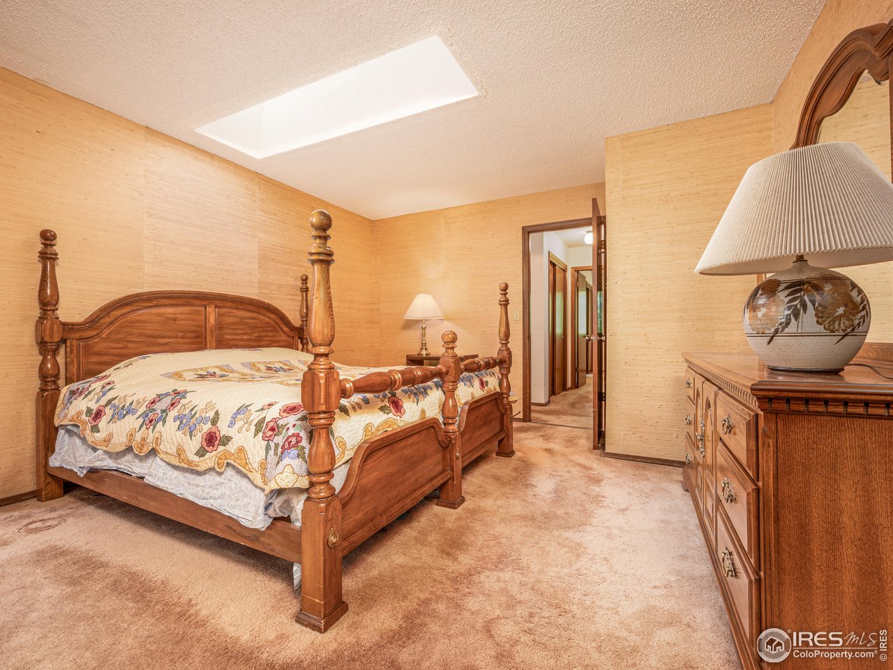 314 Eagle Court Longmont, CO 80504 - Photo 25 of 40 a spacious bedroom with a bed and dresser