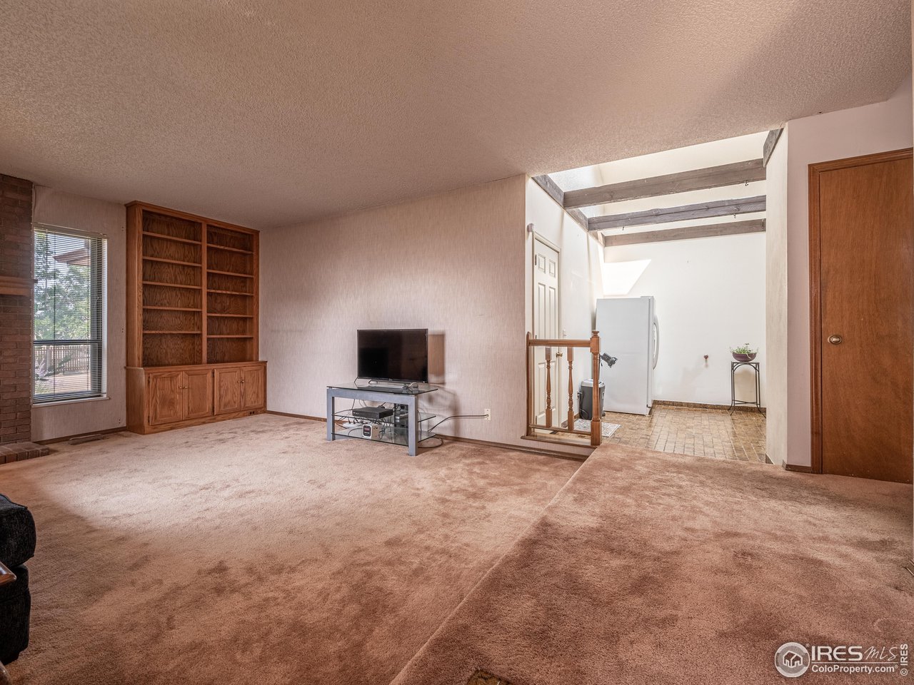314 Eagle Court Longmont, CO 80504 - Photo 8 of 40 a view of a livingroom with a flat furniture and a flat screen tv