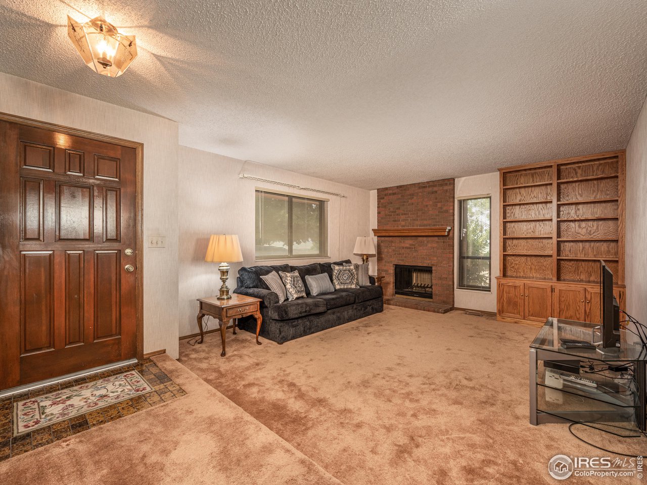 314 Eagle Court Longmont, CO 80504 - Photo 9 of 40 a living room with furniture and a fireplace
