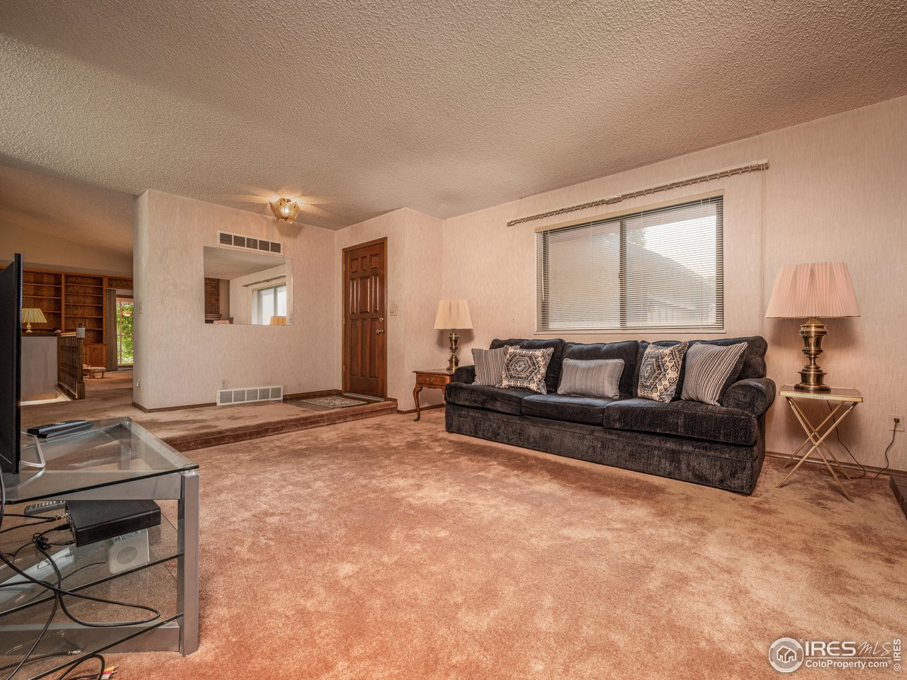 314 Eagle Court Longmont, CO 80504 - Photo 10 of 40 a living room with furniture and a flat screen tv