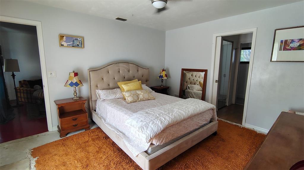 4790 Michael Lane Ponce Inlet, FL 32127 - Photo 11 of 35 a bed sitting in a bedroom next to a window