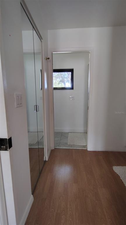 4790 Michael Lane Ponce Inlet, FL 32127 - Photo 12 of 35 an empty room with wooden floor and windows