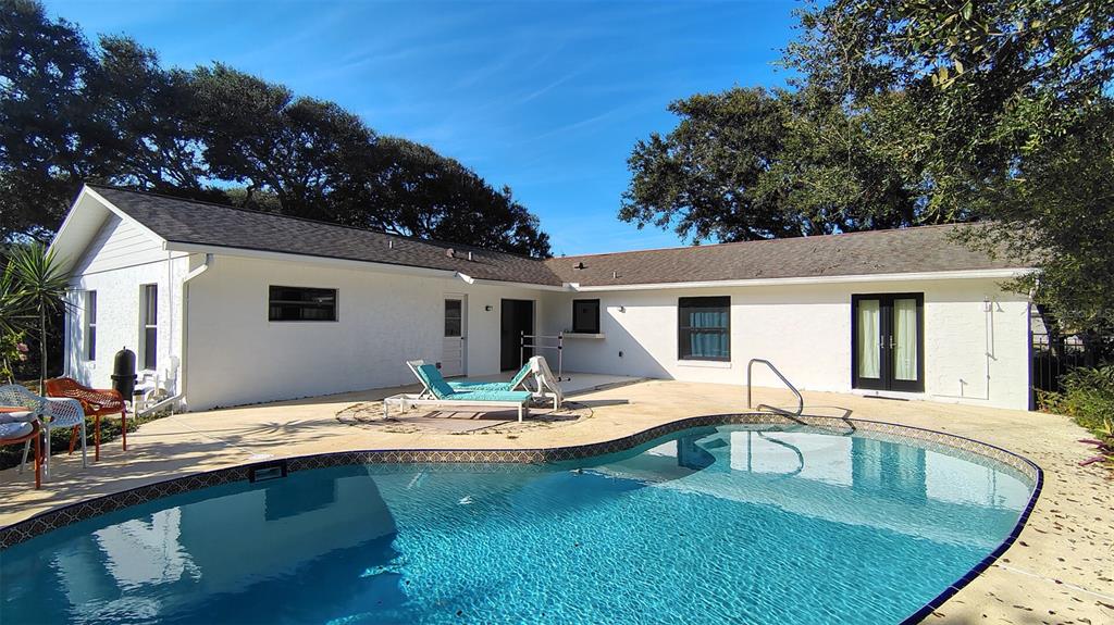4790 Michael Lane Ponce Inlet, FL 32127 - Photo 20 of 35 a view of a house with swimming pool and a dining space with furniture