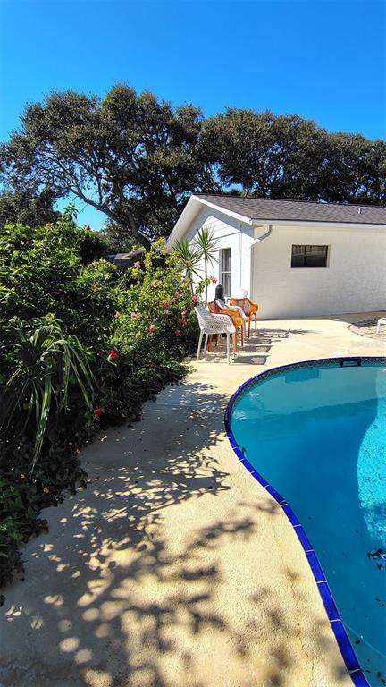 4790 Michael Lane Ponce Inlet, FL 32127 - Photo 30 of 35 a view of a swimming pool with lounge chairs