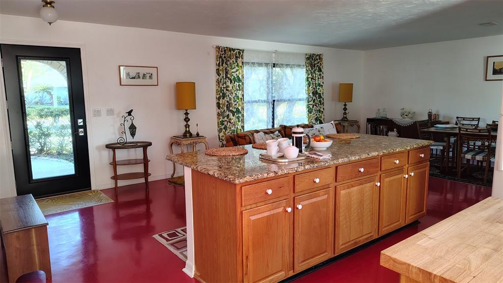 4790 Michael Lane Ponce Inlet, FL 32127 - Photo 4 of 35 a view of kitchen island sink dining table and chairs