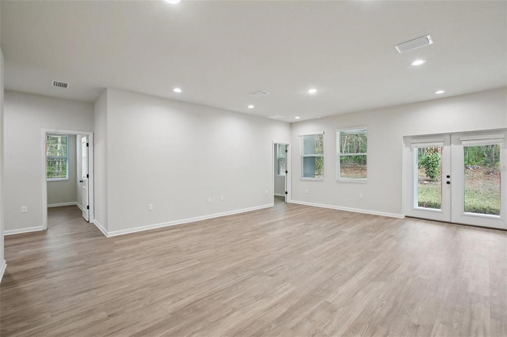 64 Cactus Street Homosassa, FL 34446 - Photo 3 of 12 a view of an empty room with wooden floor and a window