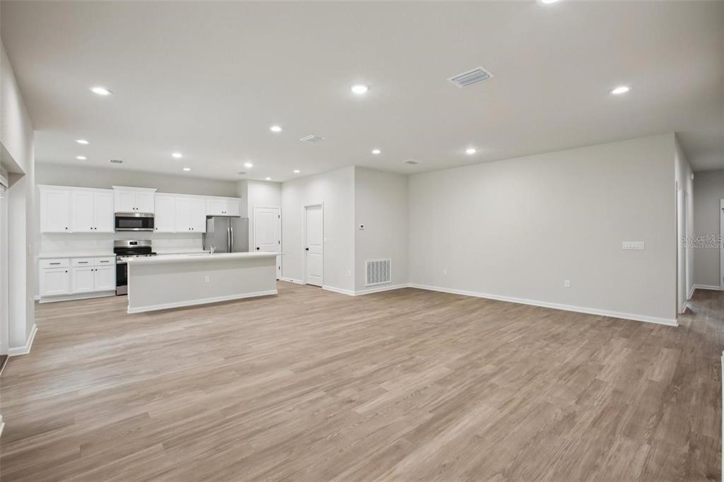 64 Cactus Street Homosassa, FL 34446 - Photo 5 of 12 a view of kitchen with white cabinets and stainless steel appliances