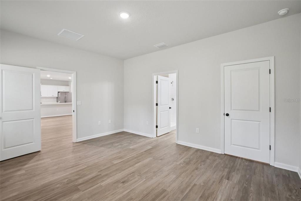 64 Cactus Street Homosassa, FL 34446 - Photo 9 of 12 a view of an empty room with wooden floor
