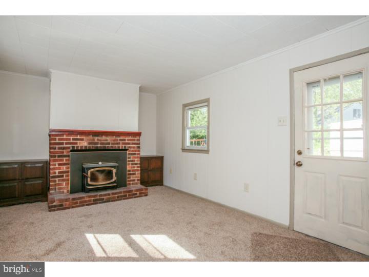 2410 Secane Road Secane, PA 19018 - Photo 8 of 25 an empty room with windows and fireplace